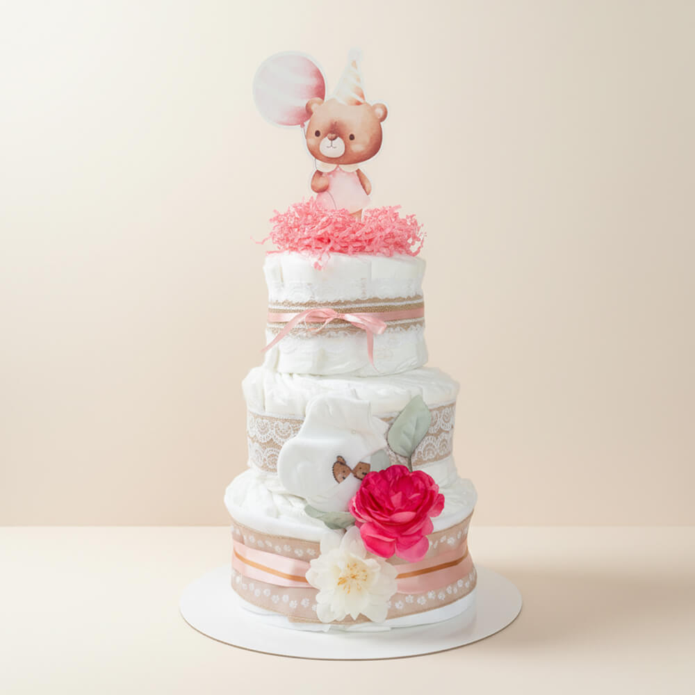 Stor blekage i lyserød med pynt og blomsterdetaljer som gave til pige babyshower